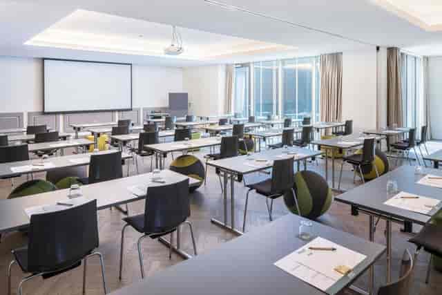 Modern classroom-style conference room at Hotel MAXX Vienna with ergonomic seating for meetings.
