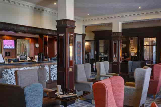 The Gathering Bar lounge at Braid Hills Hotel, featuring architectural pillars for networking.