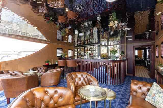 Bridge Lounge: VIP cocktail reception space with plush leather seating for networking events.