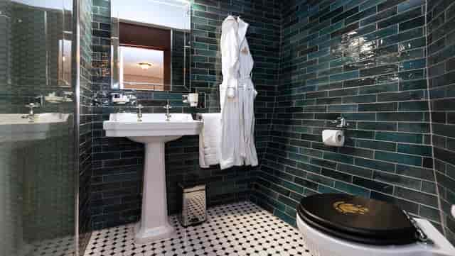 Luxury hotel bathroom in Ocean Mist with elegant vanity for VIP room blocks and event lodging.