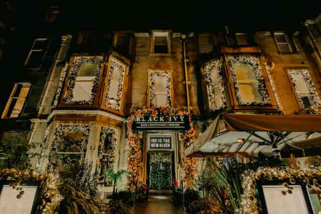 Black Ivy restaurant exterior with lush floral decor for upscale boutique events and hospitality.
