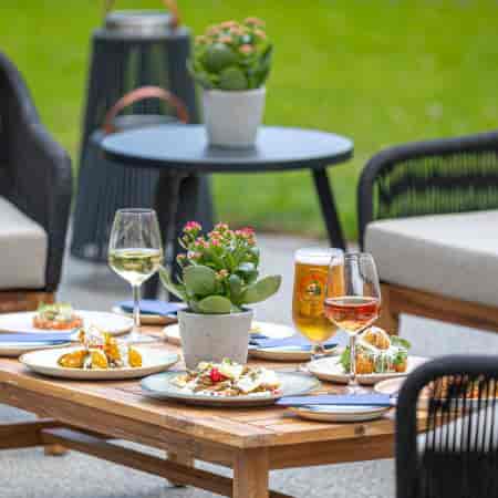 Outdoor networking event at The Brasserie: lounge seating, craft drinks, and corporate mixers.