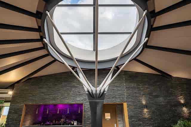 Water Lily suite at The Vu with stone walls and skylight for modern events and weddings.