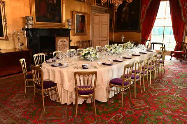 Hopetoun House State Dining Room gala dinner with purple Chiavari chairs and floral table settings.