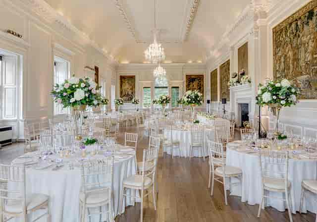 Ballroom at Hopetoun House with gala tables and floral centerpieces for weddings and events.
