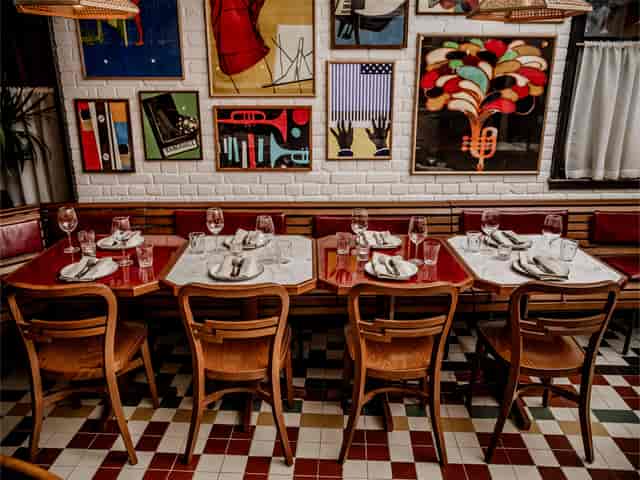 Vibrant Cafe KOKO dining space with eclectic artwork for intimate gatherings and events.