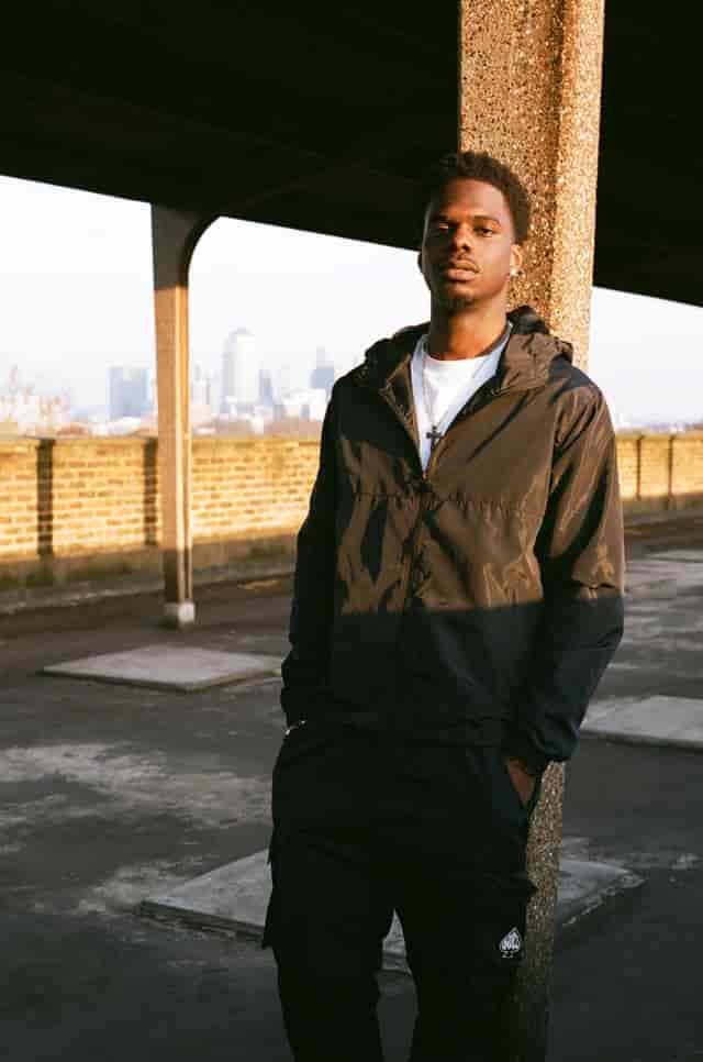 Stylish young man at East London Rooftop, ideal for urban events and photoshoots.