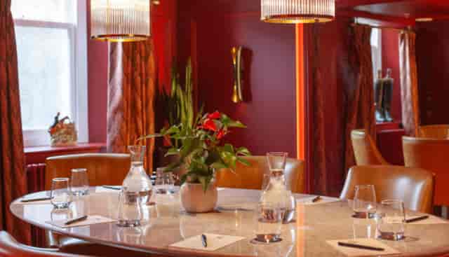 Executive boardroom at Hotel Indigo Bath with leather seating for strategy meetings.