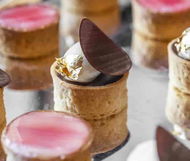 Elegant bite-sized catering with gold leaf for premium cocktail events and luxury receptions.