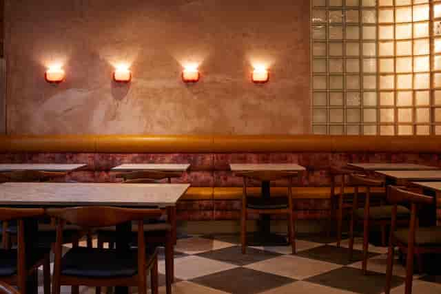 Intimate event space at The Lounge & Kebab Queen with elegant banquette seating.