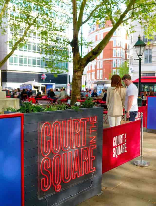 Outdoor networking event at Summer in the Square plaza, informal urban venue setup.