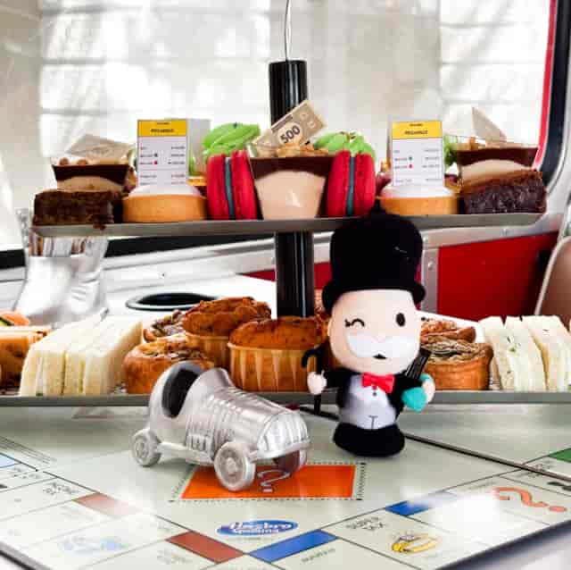 Monopoly-themed afternoon tea bus tour in London, unique branded F&B experience.