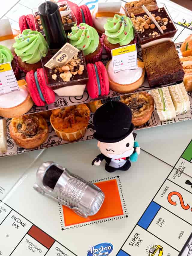 Monopoly-themed afternoon tea bus tour in London, immersive luxury networking event.
