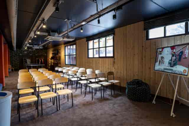 Industrial-chic workshop space at MOB Hotel with theater seating for collaborative events.