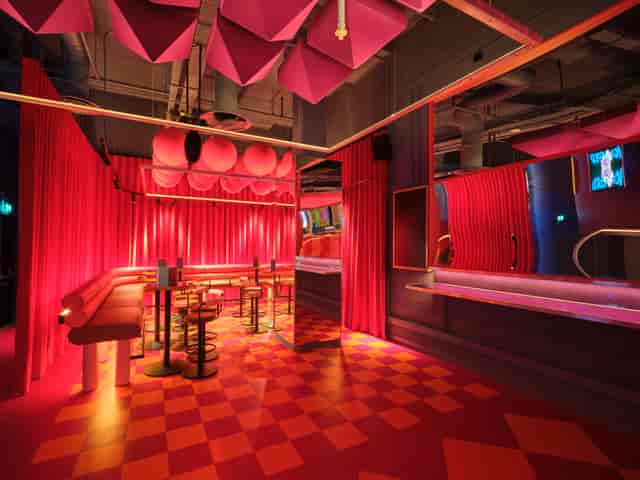 Vibrant Fun House event space with bold pink decor for networking and social gatherings.