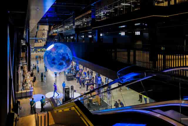 Large moon installation in Vertu Place, Co-op Live: versatile event space for gatherings.