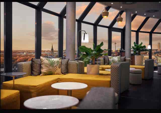 Rooftop terrace at Wasserturm Hotel featuring modular lounge seating for networking or cocktail events.