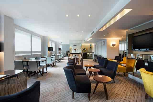 Modern lounge area in Hilton London Tower Bridge for networking events and meetings.