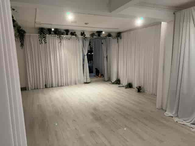 Minimalist event studio with wood floors for boutique workshops and yoga sessions.