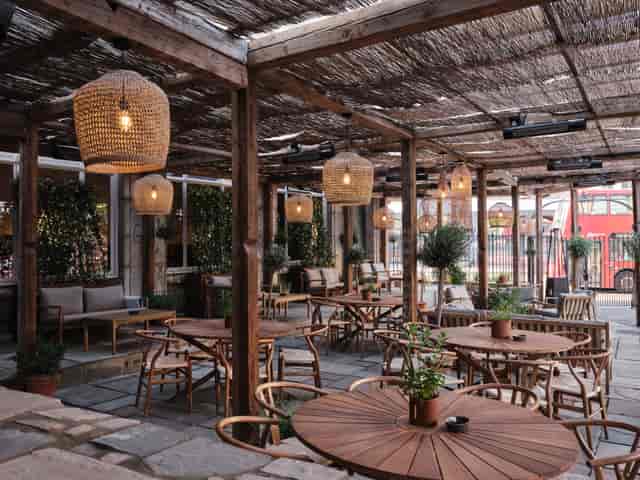 Charming outdoor venue with warm lighting for casual meetings and team gatherings.