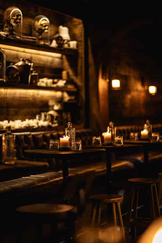 Upscale Rhum Tavern cocktail bar with tufted booths for VIP networking and corporate receptions.
