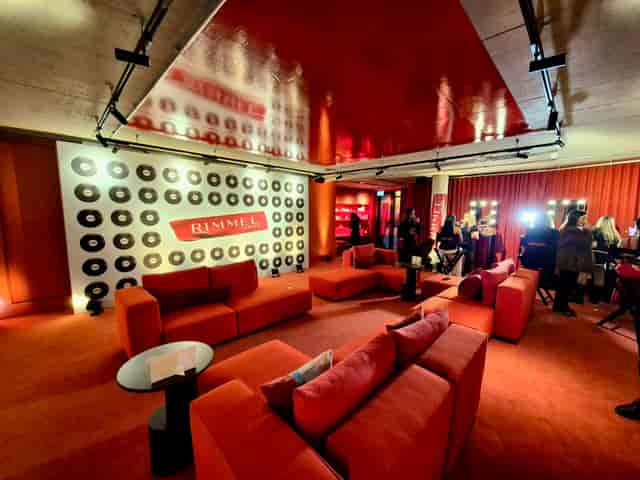 Monochromatic brand activation with step-and-repeat wall for networking event and experiential design.