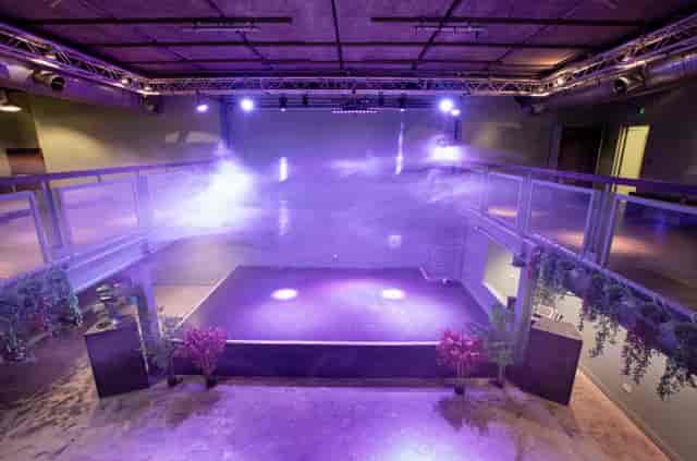 Acres23 industrial-chic event venue with stage, ideal for product launches and modern receptions.