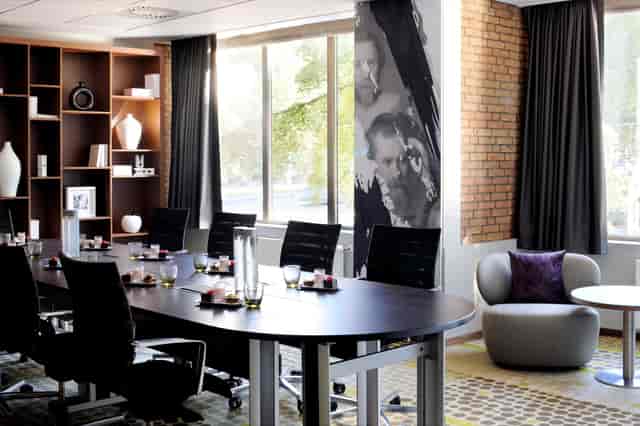 Modern meeting room with large windows at Amsterdam Marriott Hotel for corporate events.