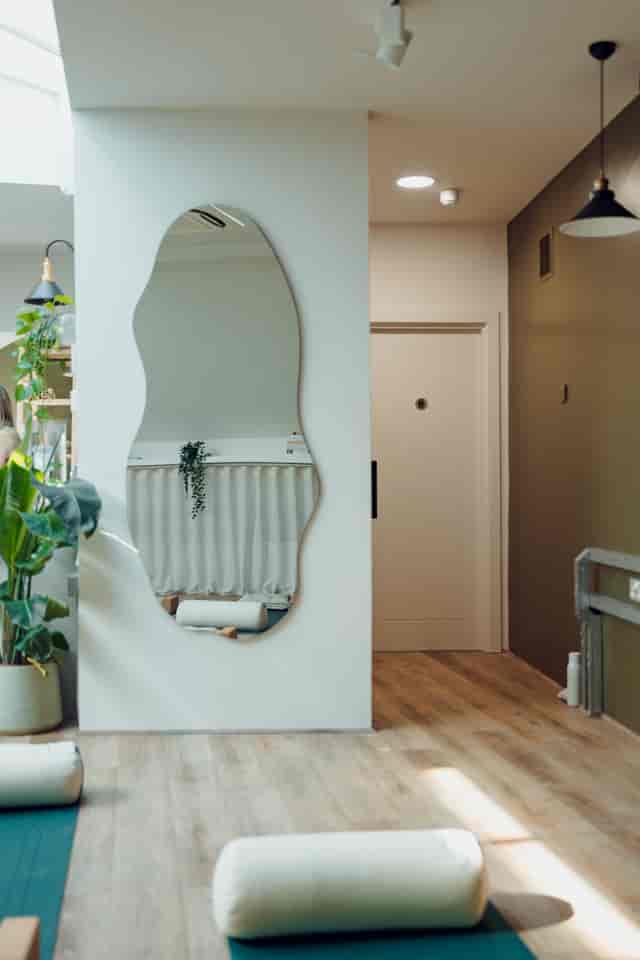 Calm wellness studio with organic mirror for corporate retreats and mindfulness workshops.