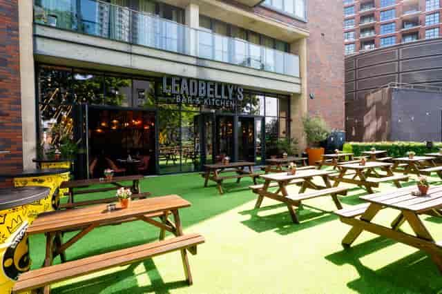 Outdoor terrace networking space with communal seating for informal corporate receptions.