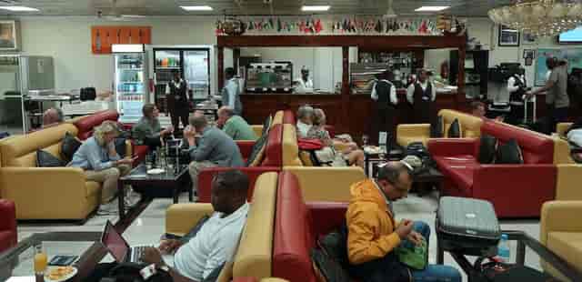 Airport lounge with business travelers, ideal for networking events and corporate coworking.