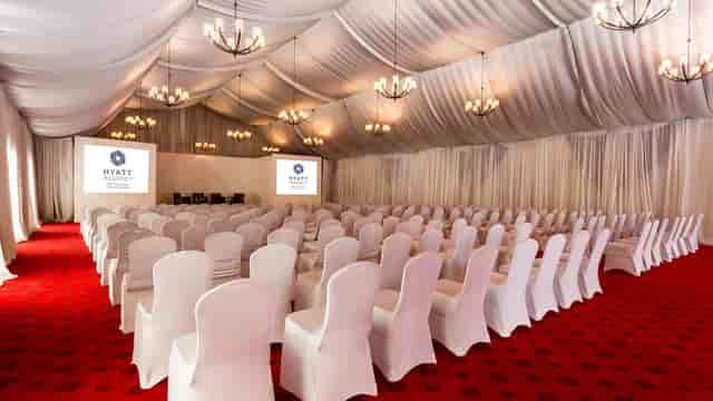 Kinaya ballroom with draped ceiling for a corporate plenary or professional conference session.