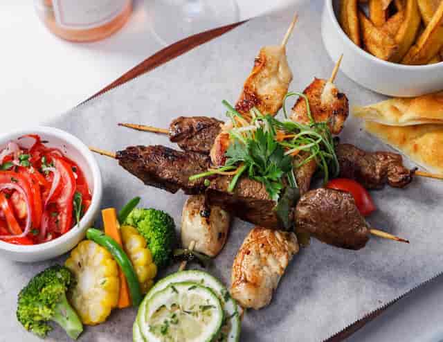 Catering platter with skewers and pita for casual networking lunch or cocktail reception.
