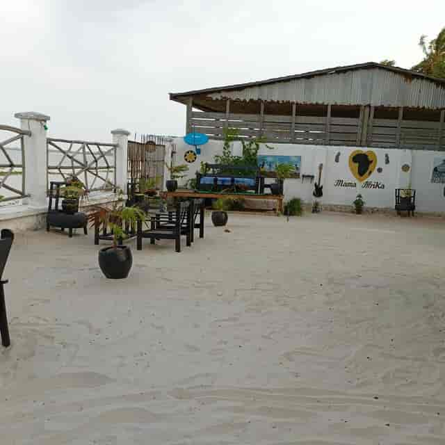 Rustic outdoor restaurant with sand floor, perfect for networking mixers and cocktail receptions.