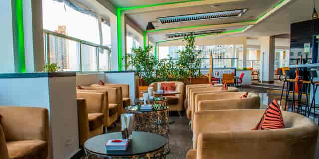Rooftop lounge seating with conversational clusters for upscale networking reception events.