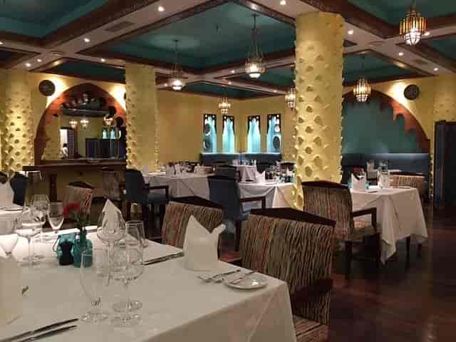Upscale dining room with arched alcoves, ideal for corporate dinners and social events.