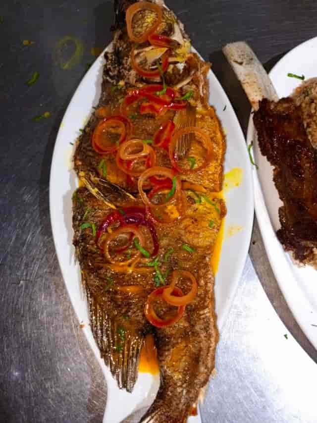 Caribbean escovitch fish on plate for rustic catering event menu