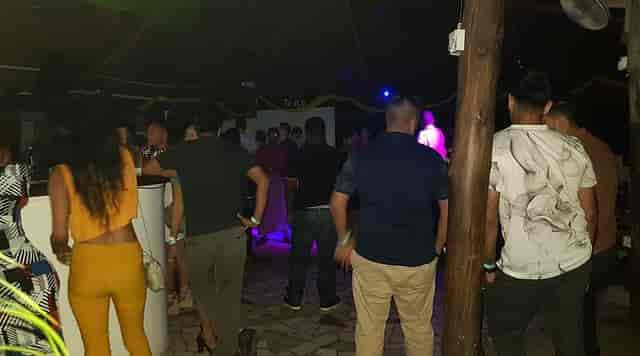 Crowded Triniti bar nightlife event with dim lighting and congested social atmosphere.