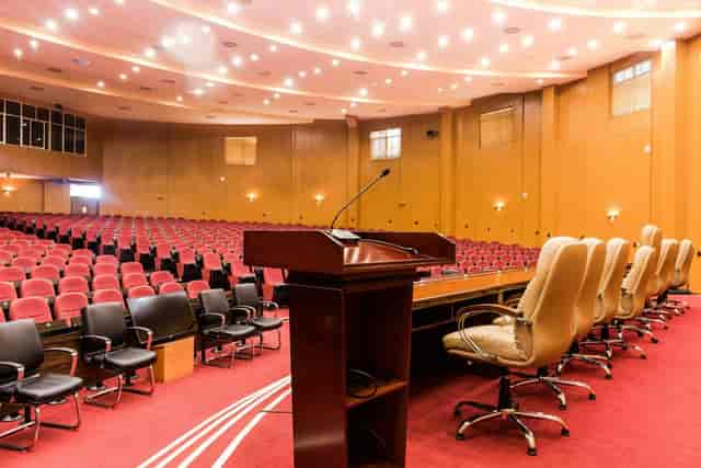Auditorium meeting room at APC Hotel with stage for corporate conferences and keynote events.