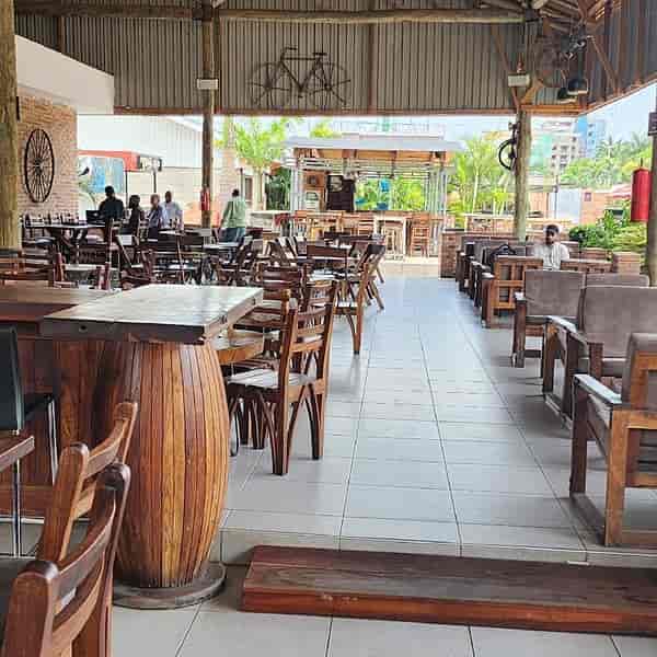 Rustic outdoor patio with barrel tables for networking events and team building.