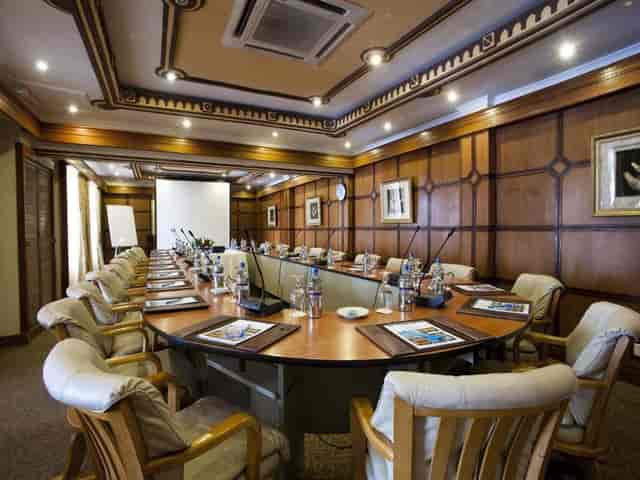 U-shaped boardroom with high-back chairs at Kunduchi Beach Hotel, perfect for corporate meetings.