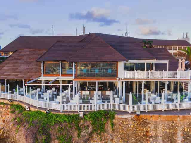 Upscale coastal restaurant with multi-level outdoor seating for incentive dinners and receptions.