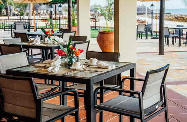 Kisiwa Bar open-air breakout space with beachfront tables for corporate networking and events.