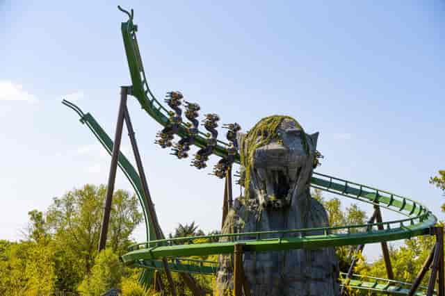 "Thrilling roller coaster near lion sculpture at Chessington World of Adventures for corporate events."