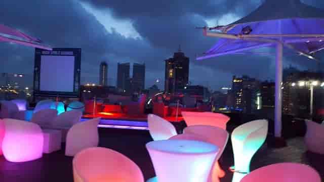 Rooftop lounge bar in Dar es Salaam with mood lighting for networking events and corporate functions.
