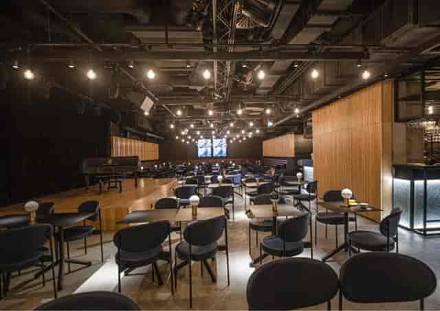 Jasmine reception venue: cabaret-style seating with stage for corporate events and workshops.