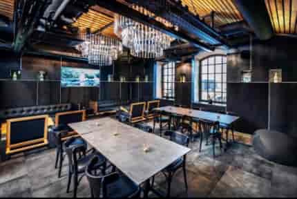 VIP lounge at Polish Vodka Museum with industrial-chic chandeliers for corporate events or galas.