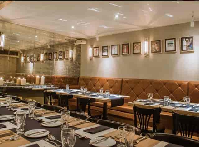Private dining room with tiered seating for corporate dinners and networking events.
