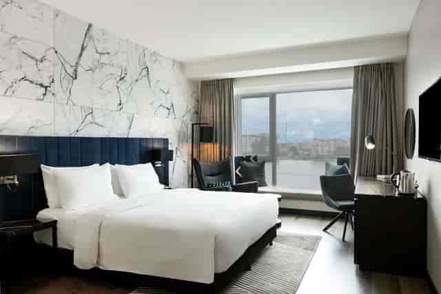 Contemporary hotel room with desk for executive travel and VIP corporate events.