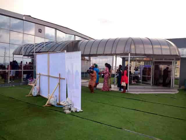 Lekki Coliseum rooftop conference hall with branded step-and-repeat for corporate event planning.